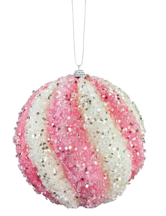 a pink and white ornament hanging from a string