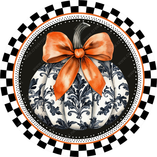 a pumpkin with a bow on top of it
