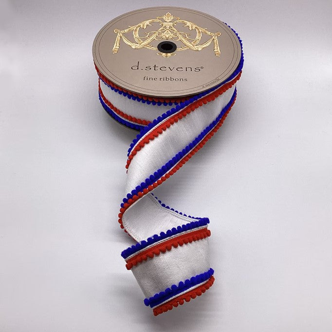 A roll of red, white, and blue ribbon with a decorative trim, placed on a plain background.