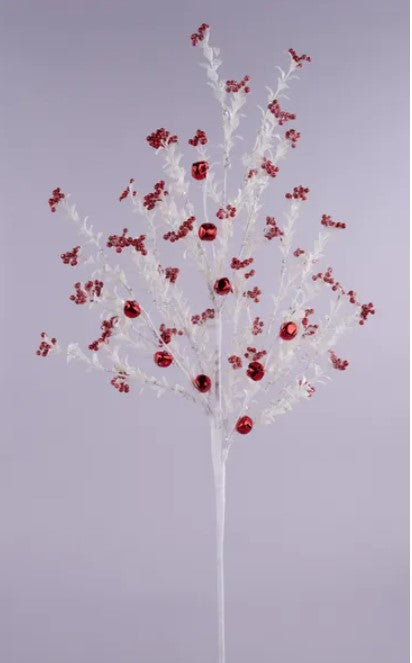 A white branch adorned with red berries and bells, creating a festive and decorative arrangement.