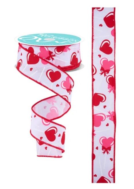 a ribbon with a heart pattern and a spool of ribbon with a heart pattern.