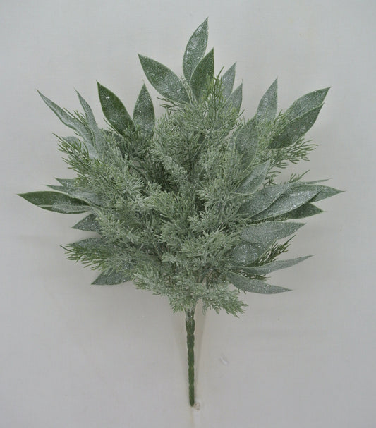A bunch of green leaves with a frosty appearance, resembling a winter scene.