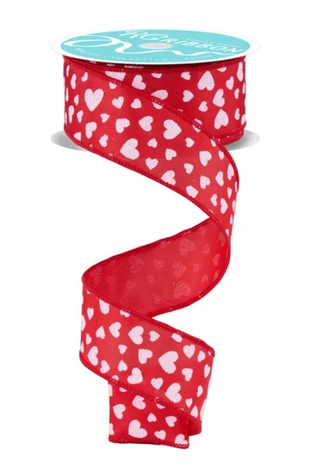 A red ribbon with a pattern of white hearts on it.