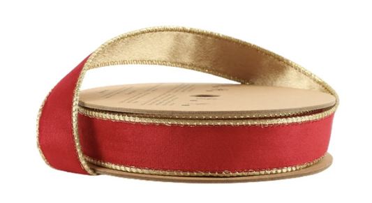 A close-up image of a red and gold ribbon spool with a gold-colored spool.