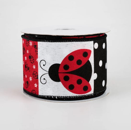 a red and black ribbon with a ladybug on it