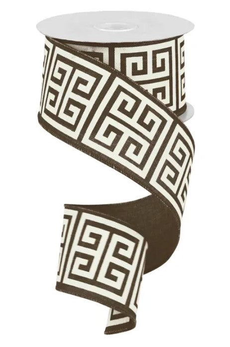 A roll of black and white patterned ribbon with a repeating geometric design.