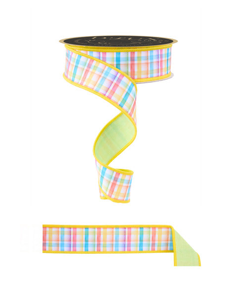 a spool of yellow and green plaid ribbon next to a spool of yellow