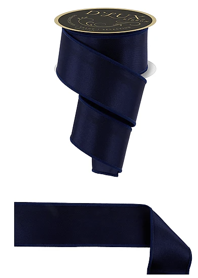 a dark blue satin ribbon with a gold label, and a plain white ribbon below it.