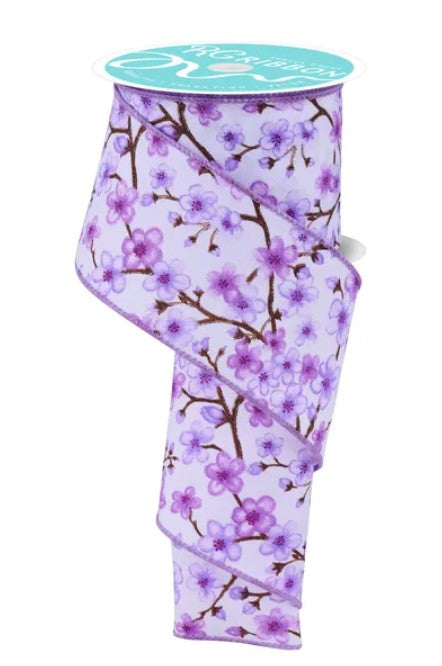 a ribbon with a floral pattern of purple flowers on brown branches.