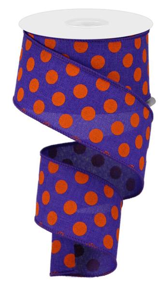 a roll of purple and orange polka dot ribbon