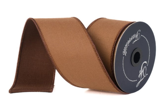 A roll of brown fabric ribbon with a black label on it.
