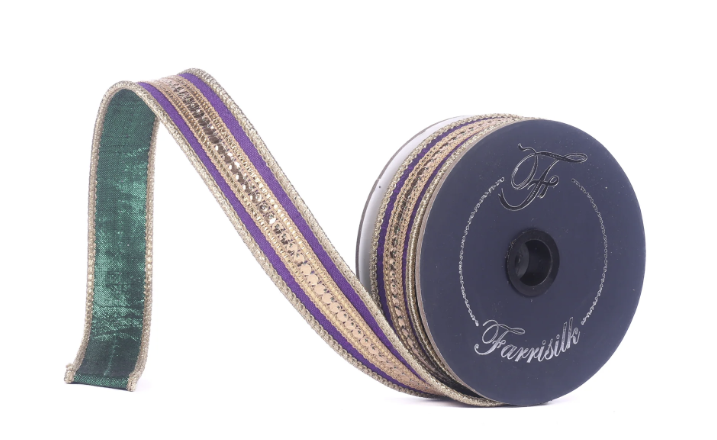 A spool of decorative ribbon with a green and gold pattern, featuring a black and gold design.
