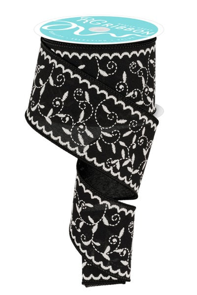 a roll of black and white ribbon on a white background
