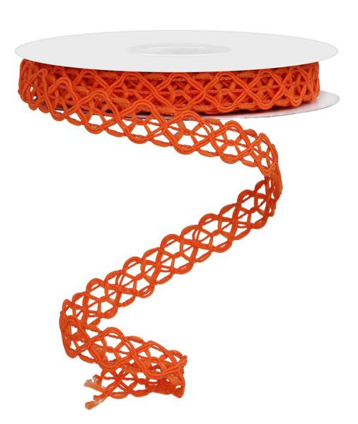 a spool of orange ribbon on a white surface