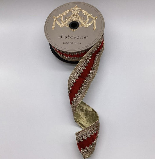 A spool of ribbon with a decorative pattern of red and gold trim, placed on a white background.