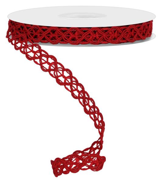 a roll of red ribbon sitting on top of a white table