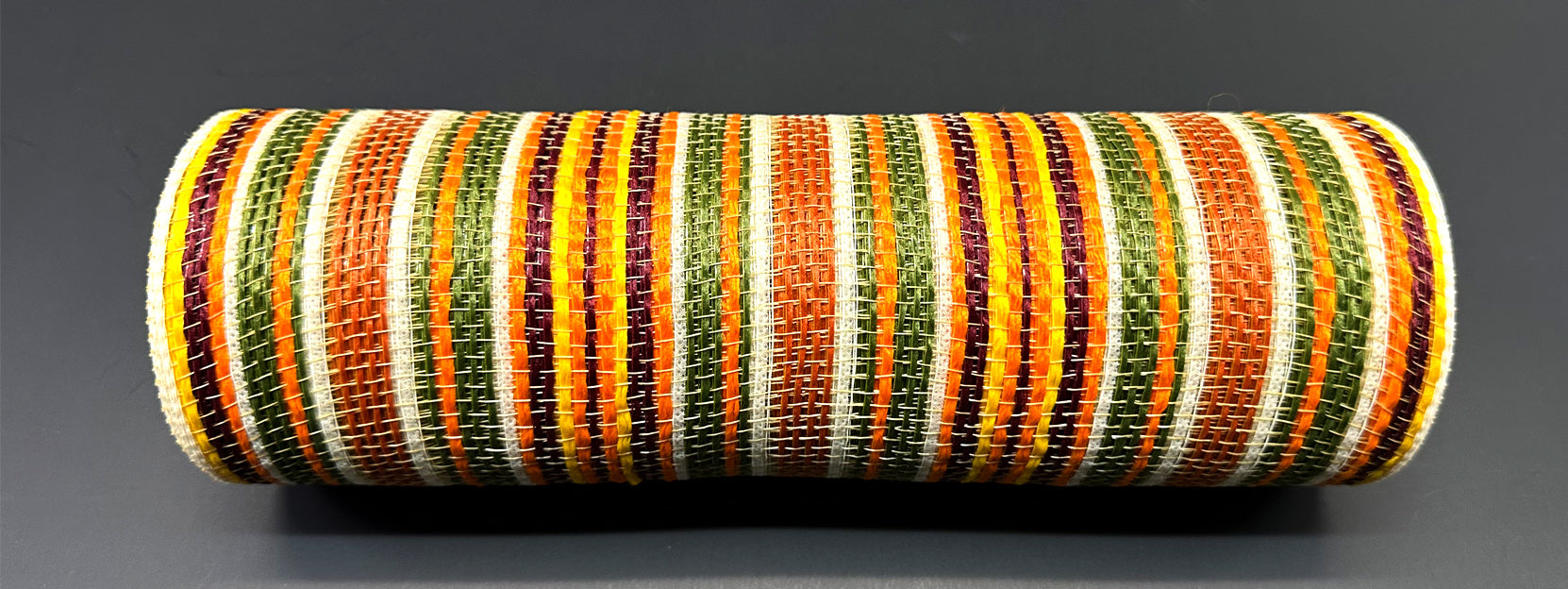 a roll of orange, green, yellow and white striped ribbon