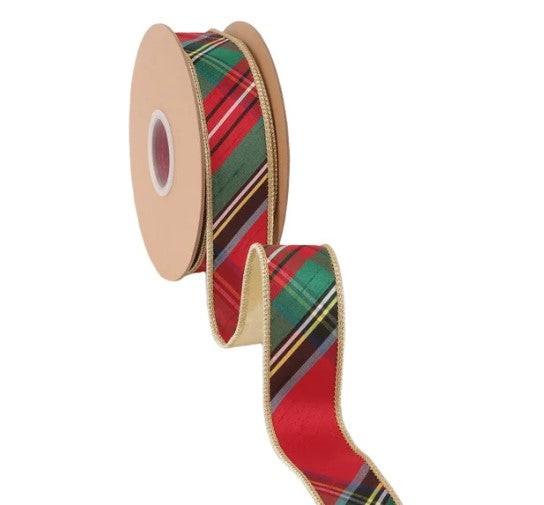 A roll of red, green, and yellow plaid ribbon is shown against a white background.