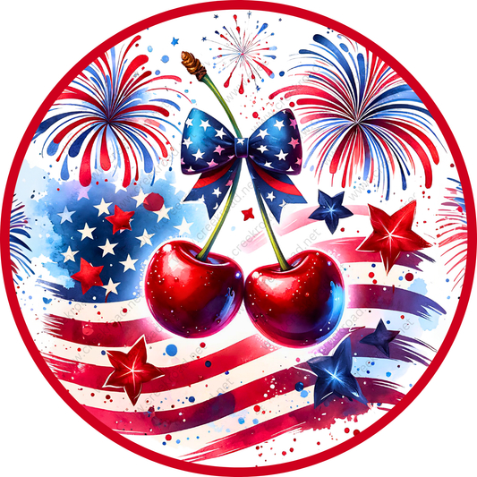 The image is a vibrant and patriotic collage featuring a red, white, and blue color scheme, with a large American flag in the background. The collage includes a pair of cherries, fireworks, stars, and a bow, all set against the backdrop of the flag.