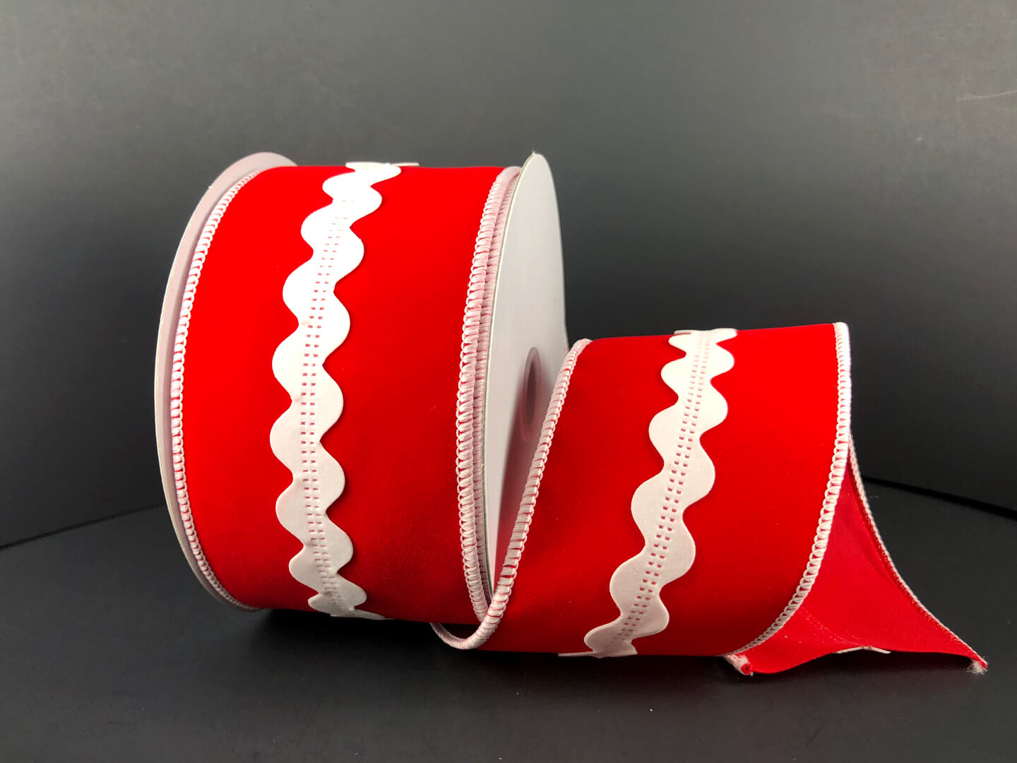 a roll of red and white ribbon on a table