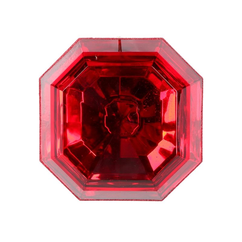 a close up of a red jewel on a white background