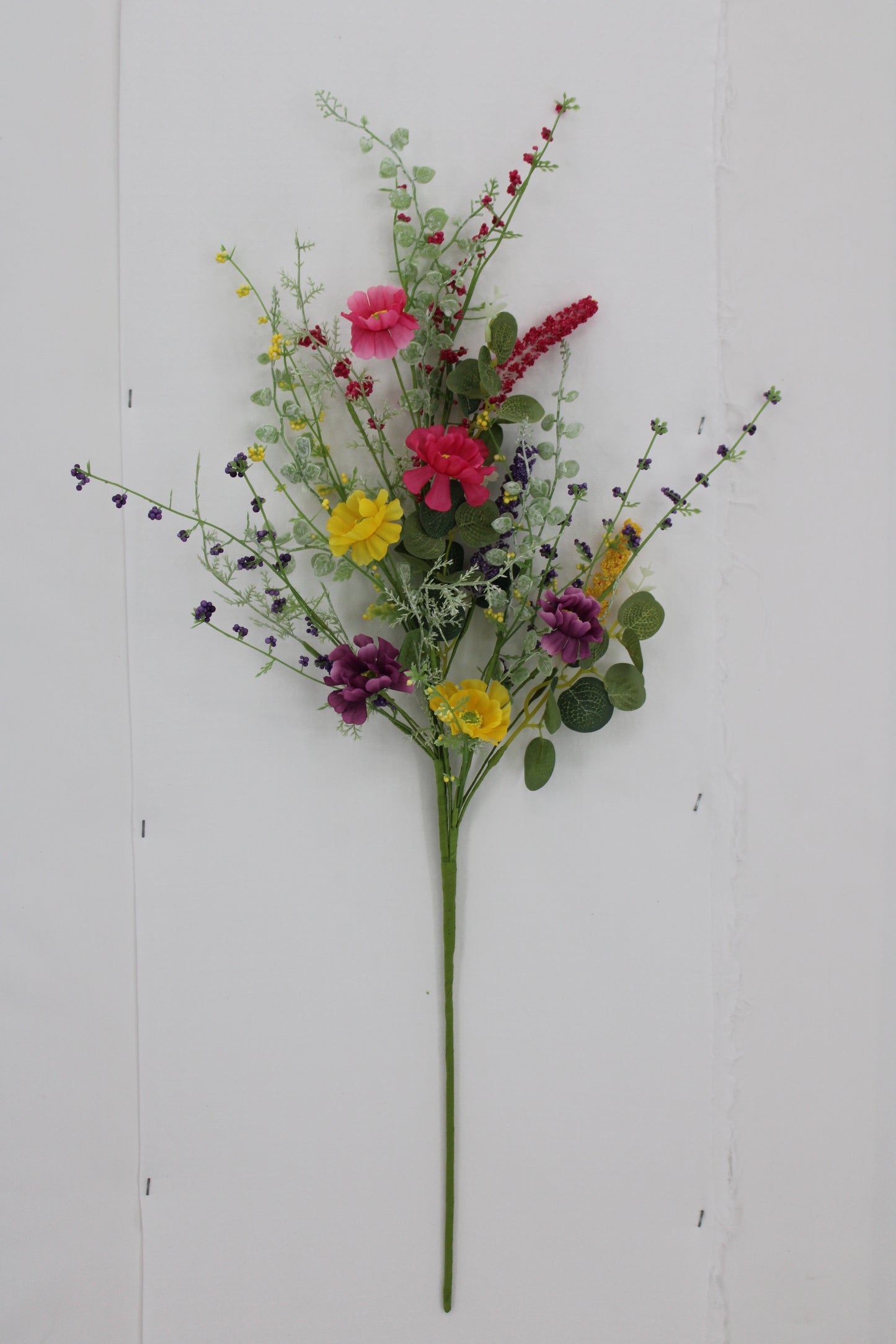 A bouquet of colorful flowers, including red, pink, yellow, purple, and green, is displayed against a white background.