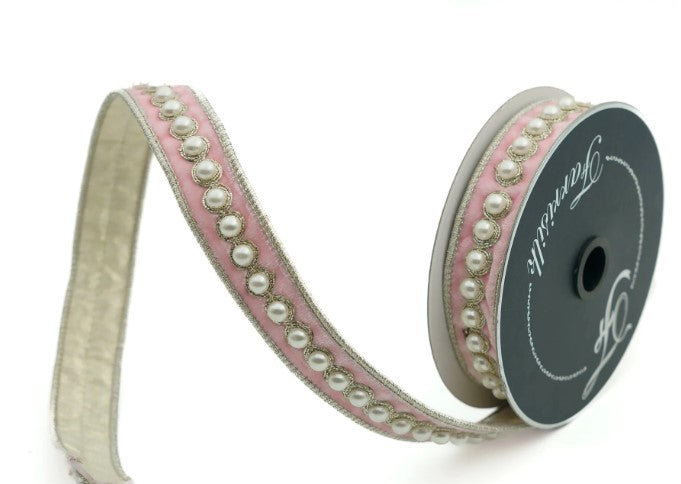 A pink and white decorative ribbon with a row of small pearls along the edge.