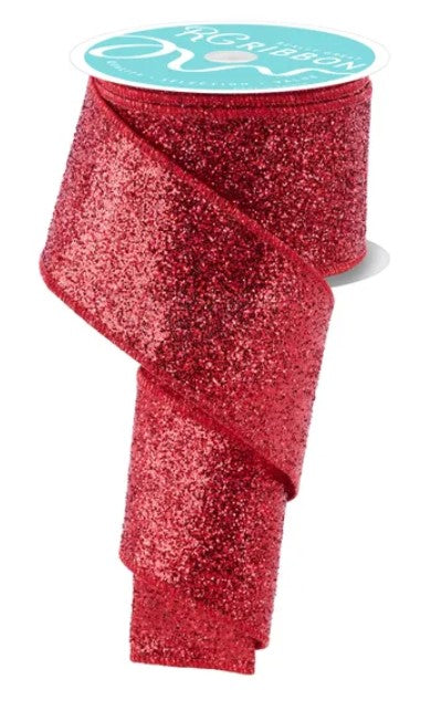 a roll of red glittery ribbon with a white label on top.