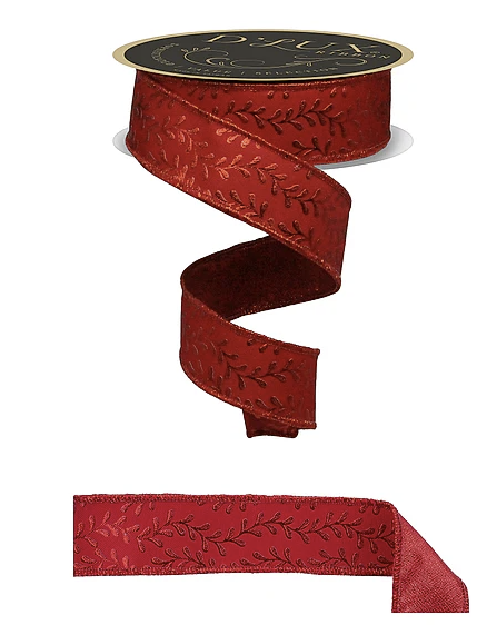 a red ribbon with a leaf pattern, and it is attached to a black circular object.