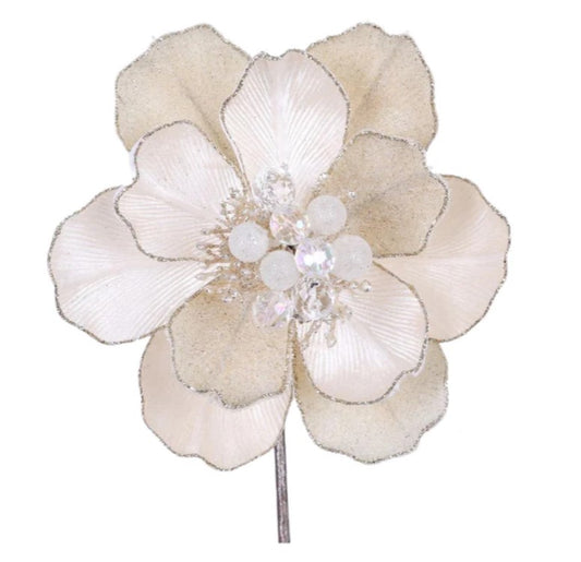 A close-up image of a delicate, white flower with a central gemstone surrounded by smaller gemstones.