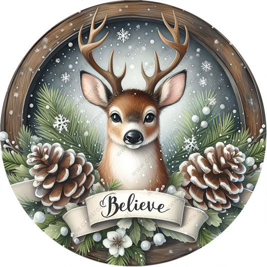 A deer with antlers is surrounded by pine cones, snowflakes, and greenery, with the word "Believe" written on a banner below.