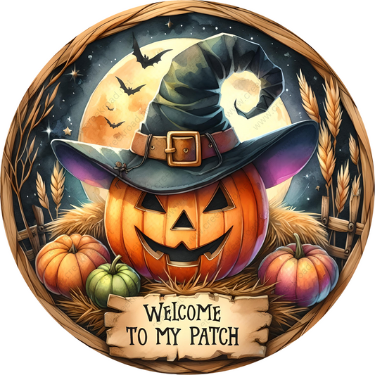 a pumpkin with a witch hat and a welcome sign