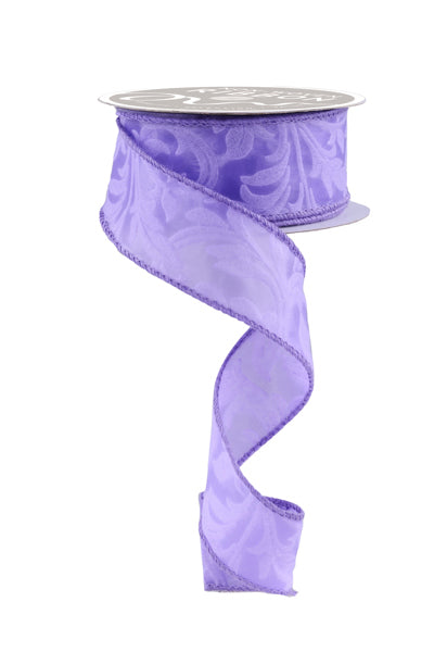 A purple floral patterned ribbon is shown, with the ribbon winding down and curving around a spool.