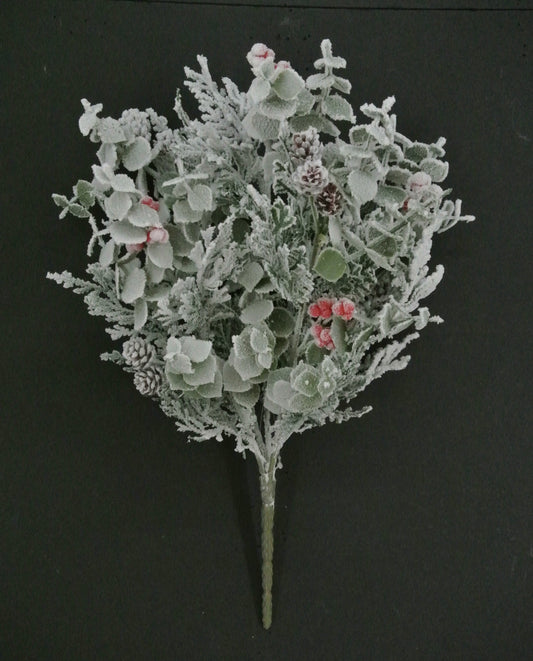 A bouquet of frosted flowers with red berries, set against a dark background.
