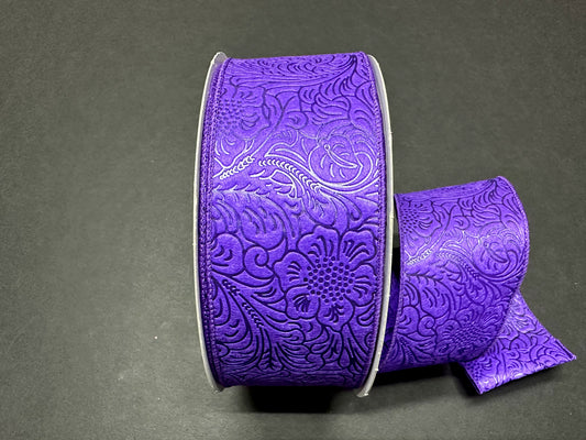 a purple ribbon with a flower design on it