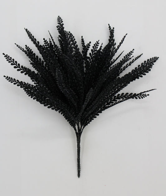 A bunch of black fake leaves or branches with a shiny, glittery appearance.