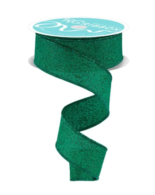 A roll of green glittery ribbon with a white label on top.