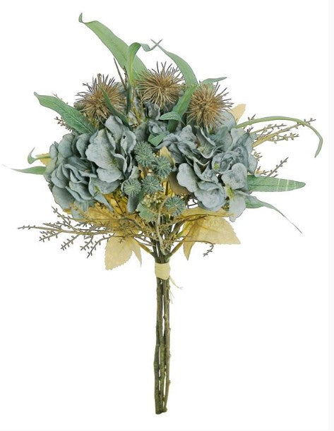 A bouquet of various flowers and foliage, including large green leaves, smaller flowers, and some spiky plant parts, tied together with a yellow ribbon.