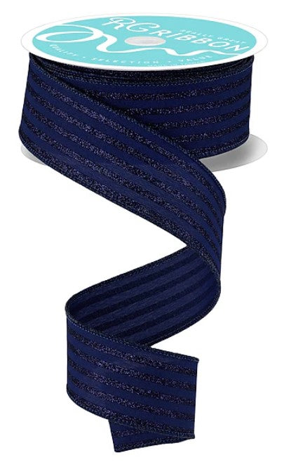 A spool of navy blue ribbon with a white label that reads "The Ribbon" and "The Ribbon" in a teal color.
