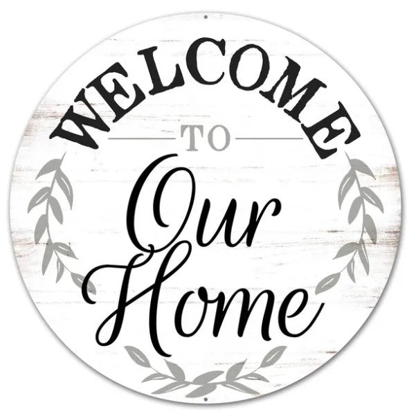 A white sign with the text "Welcome to Our Home" written in a decorative font.