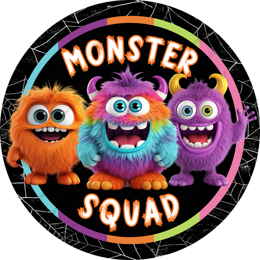 a round sticker with three monsters on it