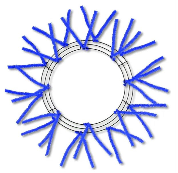 A circular wreath made of blue pipe cleaners, with the pipe cleaners arranged in a radial pattern around the center of the wreath.
