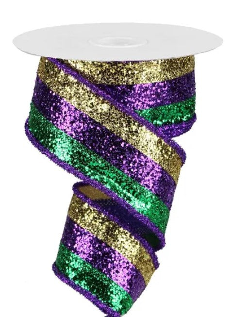 A decorative ribbon with a multicolored, glittery pattern in shades of purple, green, and gold.