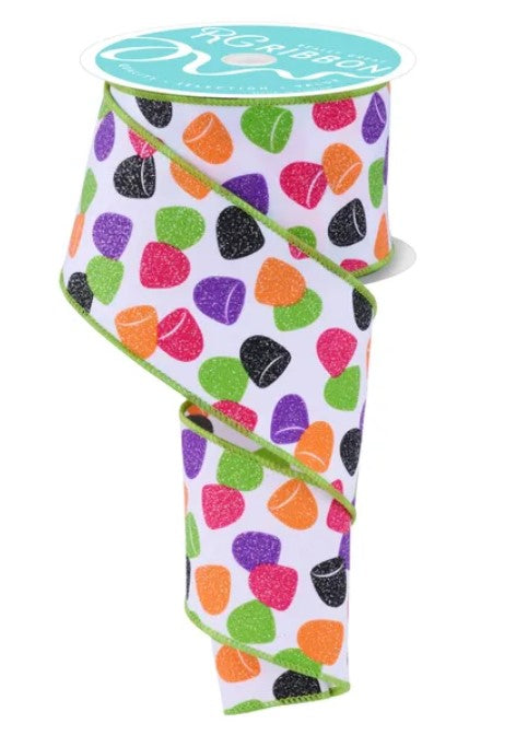 A roll of ribbon with a colorful, multicolored pattern of hearts and dots on it.