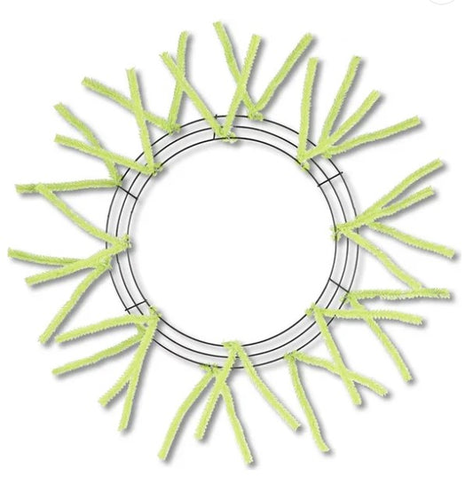 A circular wreath made of green pipe cleaners arranged in a radial pattern.