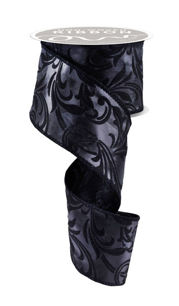 a roll of black satin ribbon on a white background