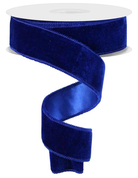 a roll of blue velvet ribbon on a white background