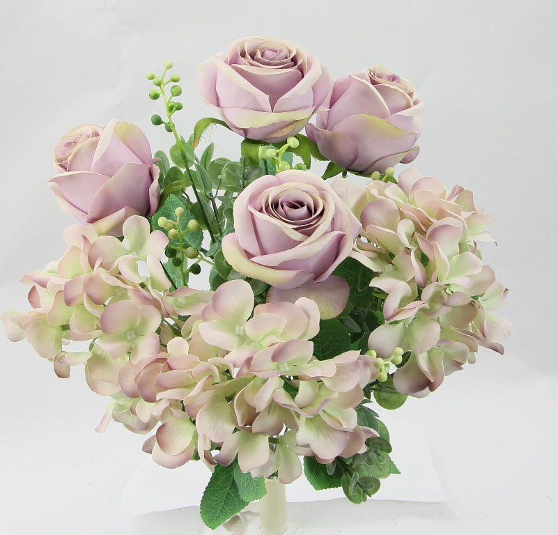 A bouquet of pink roses and white hydrangeas arranged in a vase.