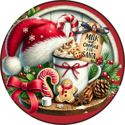 A festive Christmas scene with a mug of hot chocolate, a Santa hat, cookies, a gingerbread man, and other holiday decorations arranged on a wooden surface.