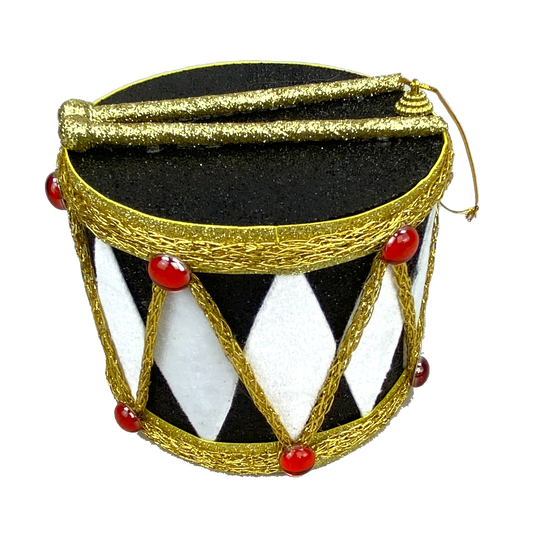 A decorative drum-shaped container with a black and white striped pattern, gold trim, and red and gold embellishments.